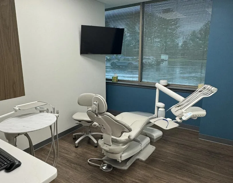 operatory with dental chair, equipment, and TV